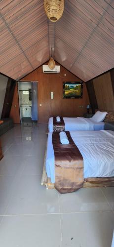 a bedroom with a large bed in a tent at Kelingking Garden Villa in Nusa Penida