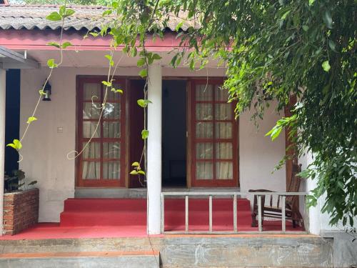 a house with red steps and a red door at Steps Garden Resort in Negombo