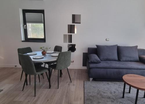 a living room with a table and a couch at TETRA Plus 569 in Breaza