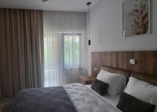 a hotel room with a bed and a window at TETRA Plus 569 in Breaza