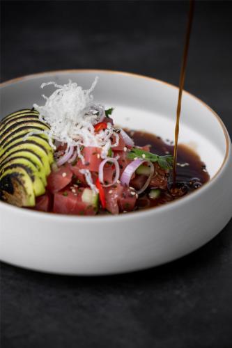 a bowl of food with a salad in it at Radisson Dubai Damac Hills in Dubai
