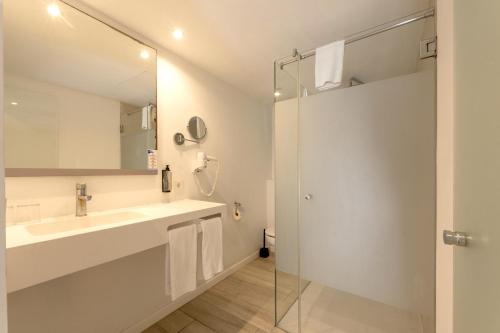 a bathroom with a sink and a shower at Hotel Club Es Talaial in Cala d´Or