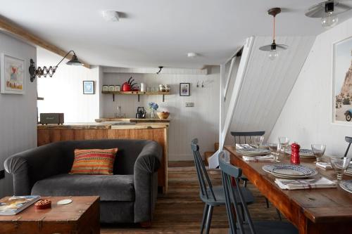 a living room with a couch and a table at Artist Residence Cornwall in Penzance