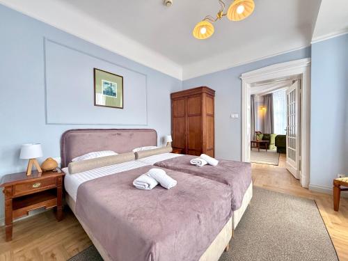 a bedroom with a bed with two towels on it at Hotel - Pokoje i Apartamenty Heban in Toruń