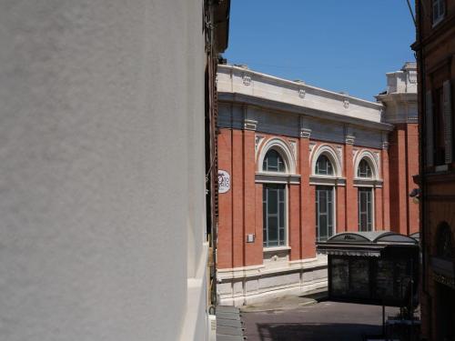 a large brick building in front of a building at San Domenico in Ravenna