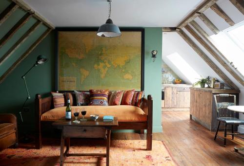 a living room with a couch and a map on the wall at Artist Residence Cornwall in Penzance