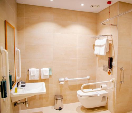 a bathroom with a toilet and a sink at Hilton Garden Inn Nairobi Airport in Nairobi