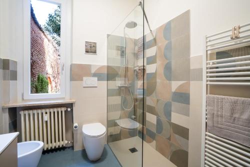 a bathroom with a toilet and a glass shower at Garavaglia Uno in Pavia