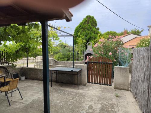 a woman standing on a fence in a backyard at Marina in Štivan