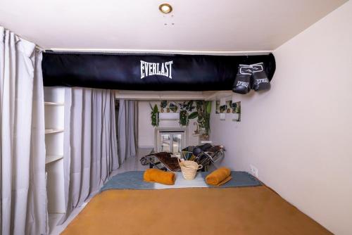 a room with a bed with a football banner on the ceiling at Duplex suite 50m de la plage Carré d'Or Nice in Nice