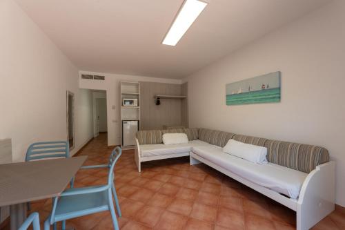 a living room with a couch and a table and chairs at Hotel Club Es Talaial in Cala d´Or