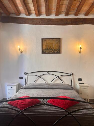 a bedroom with a bed with a red pillow on it at Affittacamere In centro in Gubbio