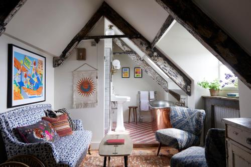a living room with a couch and two chairs at Artist Residence Cornwall in Penzance