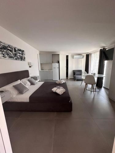 a bedroom with a large bed and a living room at Royal View Apartment in Caserta