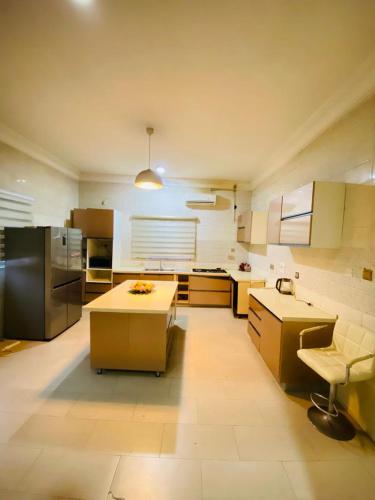 a large kitchen with a table and a chair at Luxury and Cozy family home in Ibadan