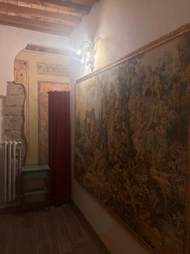 a large tapestry on a wall in a room at Affittacamere In centro in Gubbio