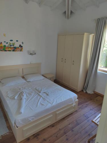 a bedroom with a bed and a cabinet and a window at Villa Casablanca with private pool in Lozenets