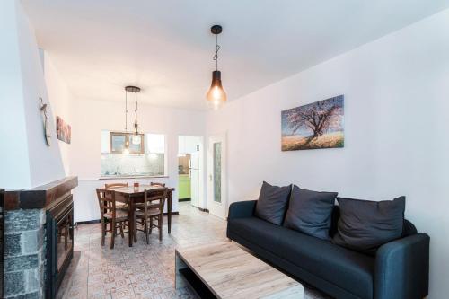 a living room with a couch and a table at The Secret Garden by Quokka 360 - flat in the hamlet of Mount Brè in Brè sopra Lugano