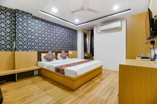 a bedroom with a bed in a room at FabHotel Surbhi in Bhopal