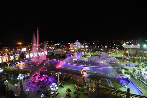 a city lit up at night with a fountain at Hollywood Aqua Park Sharm El-Sheikh in Sharm El Sheikh