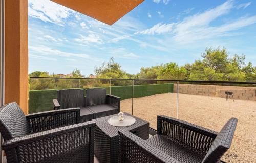 a patio with a table and chairs and a tennis court at 2 Bedroom Gorgeous Apartment In Vir in Vir