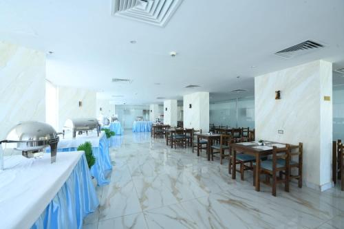 a banquet hall with tables and chairs and blue decorations at Hostmark Blue Beach Hotel in Marsa Matruh