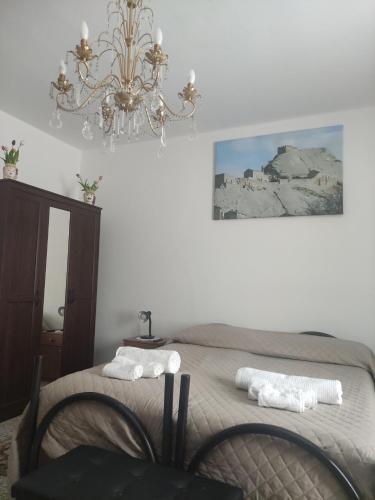 a bedroom with a bed with two towels on it at Al Municipio in Sperlinga