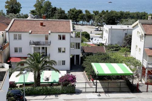 an aerial view of a white building with a green awning at Apartments Stevo Nikočević in Bar