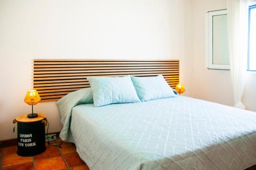 a bedroom with a large bed with a wooden headboard at Las dunas de Famara in Famara