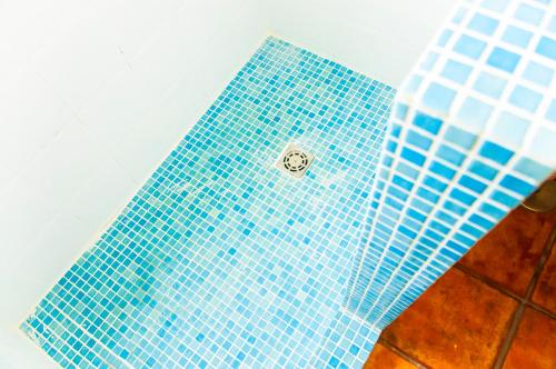 a blue tiled floor in a bathroom at Las dunas de Famara in Famara