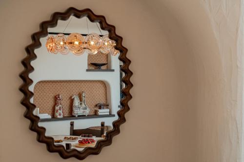 a mirror hanging on a wall with a shelf at Hotel Pitrizza, Costa Smeralda in Porto Cervo