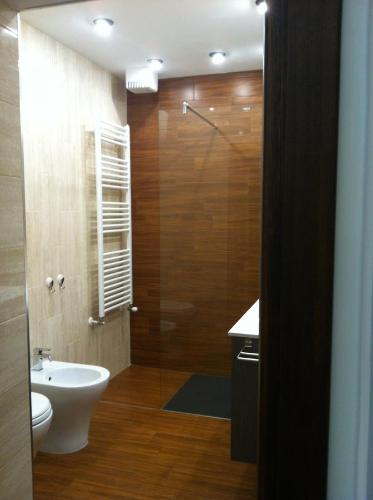 a bathroom with a shower with a toilet and a sink at Antica Dimora in Orbetello