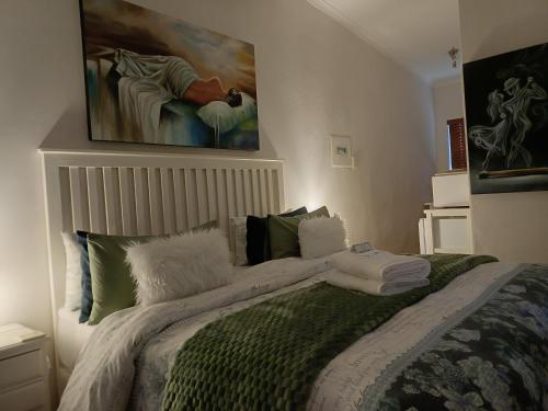 a bedroom with a bed with a painting on the wall at Cosy Stay in Robertson
