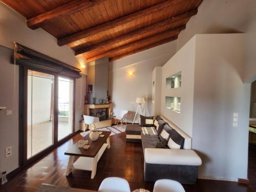a living room with a couch and a table at Spiti Loggos in Lóngos