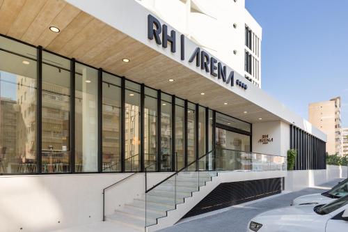 an exterior view of an office building with a car parked outside at Hotel RH Arena - Todo Incluido in Gandía