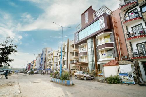 a car parked on a street next to buildings at Royal SeaView in Digha