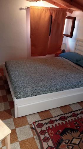 a bed in a room with a bed frame at Arco & Íris in Livorno