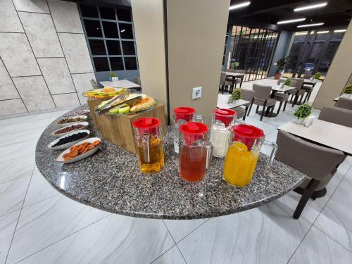 a table with some drinks and a tray of food at Art Air Hotel in Tashkent