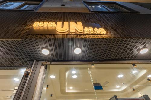 a sign on top of a store with a window at Hotel U N Star - 5 Minutes Walking Distance from New Delhi Railway Station and Metro Station in New Delhi