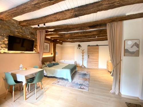 a bedroom with a bed and a table and chairs at Country loft Zarautz- San Sebastián in Aia
