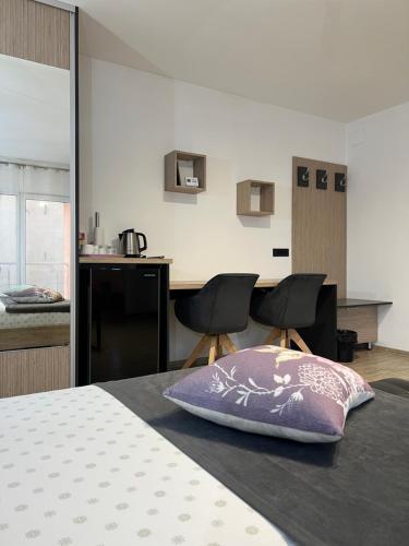 a bedroom with a bed with a pillow on it at Bruno Apartment in Cluj-Napoca