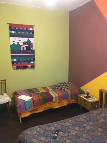a room with two beds and a painting on the wall at TERRAZAS DEL SUR in Ezpeleta