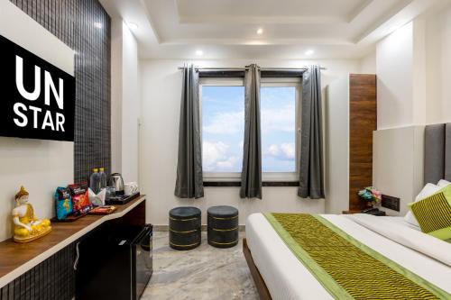 a hotel room with a bed and a window at Hotel U N Star - 5 Minutes Walking Distance from New Delhi Railway Station and Metro Station in New Delhi