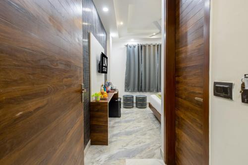 a hallway leading to a bathroom with a wooden door at Hotel U N Star - 5 Minutes Walking Distance from New Delhi Railway Station and Metro Station in New Delhi