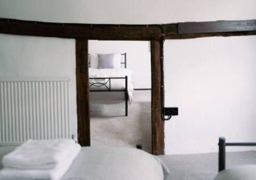 a view of a bedroom with a bed at Ye Old Shop Milton by Sheppey Stays in Kent