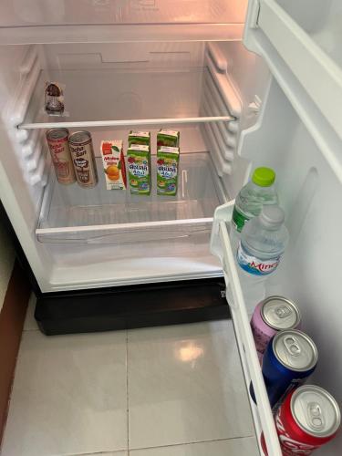 an open refrigerator filled with lots of food and drinks at 94 Yellow house in Khon Kaen