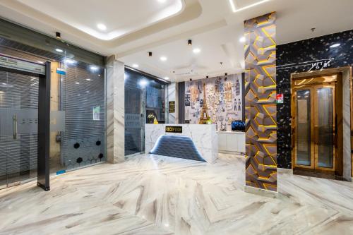 a lobby with a marble floor and a elevator at Hotel U N Star - 5 Minutes Walking Distance from New Delhi Railway Station and Metro Station in New Delhi