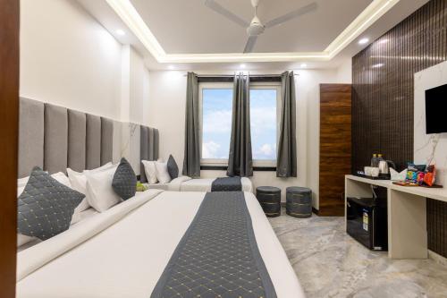 a bedroom with a large bed and a large window at Hotel U N Star - 5 Minutes Walking Distance from New Delhi Railway Station and Metro Station in New Delhi