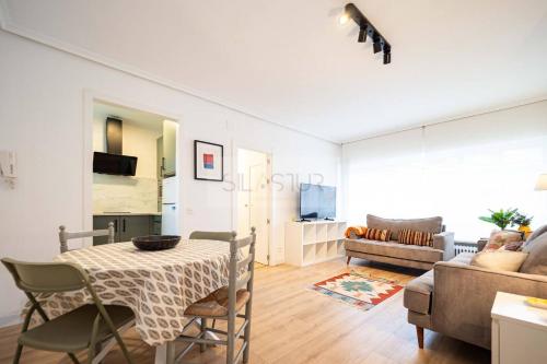 a living room with a table and a couch at La Xarrina By Silastur in Llanes