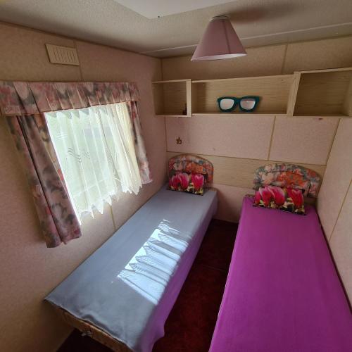 a small room with a purple table and two chairs at Vacation by the sea in Lapmežciems